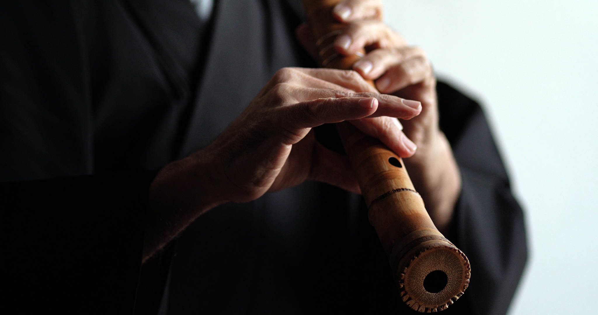 Man playing the bamboo flute shakuhachi