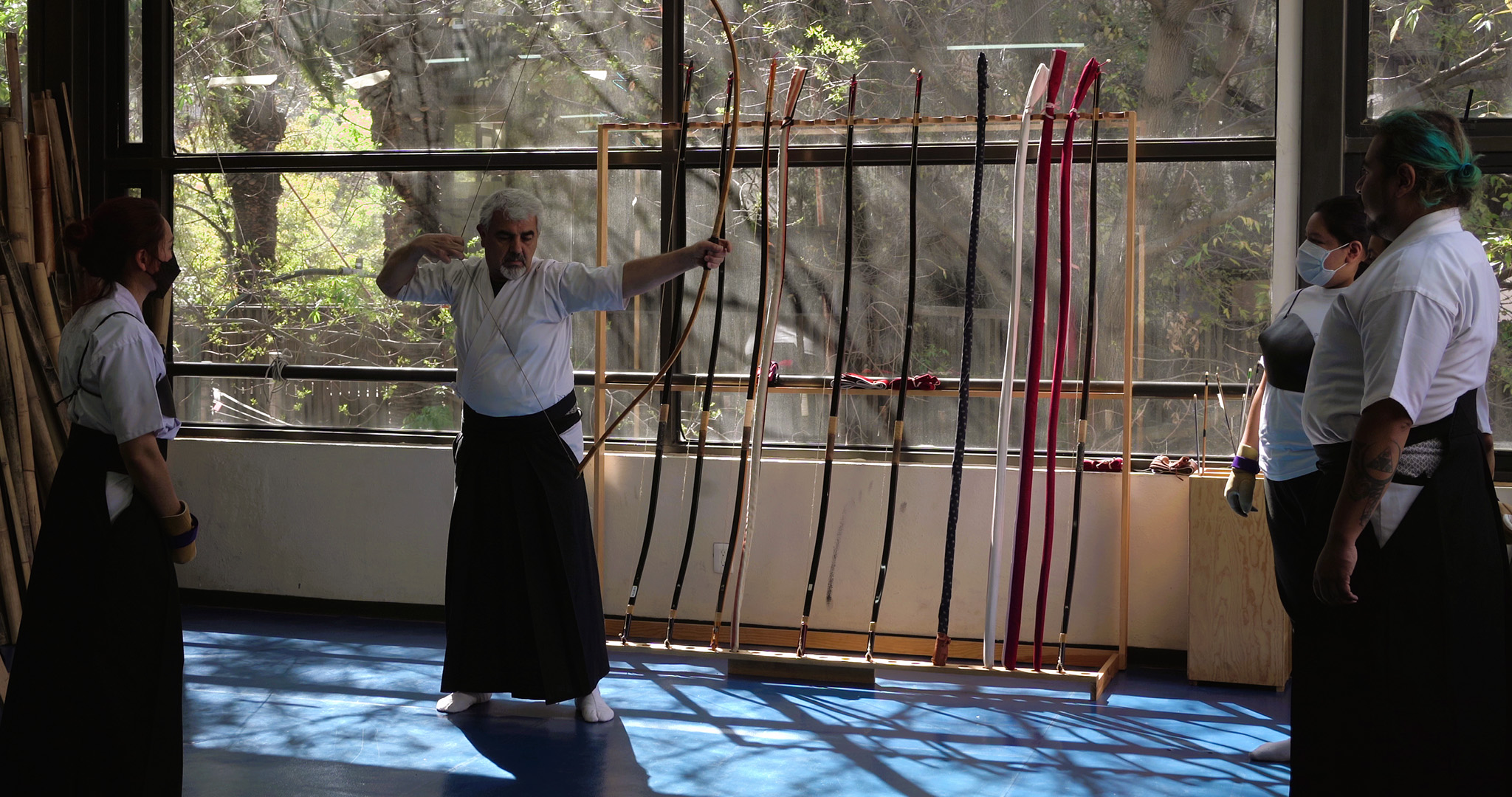 A kyudo instructor is preparing the bow