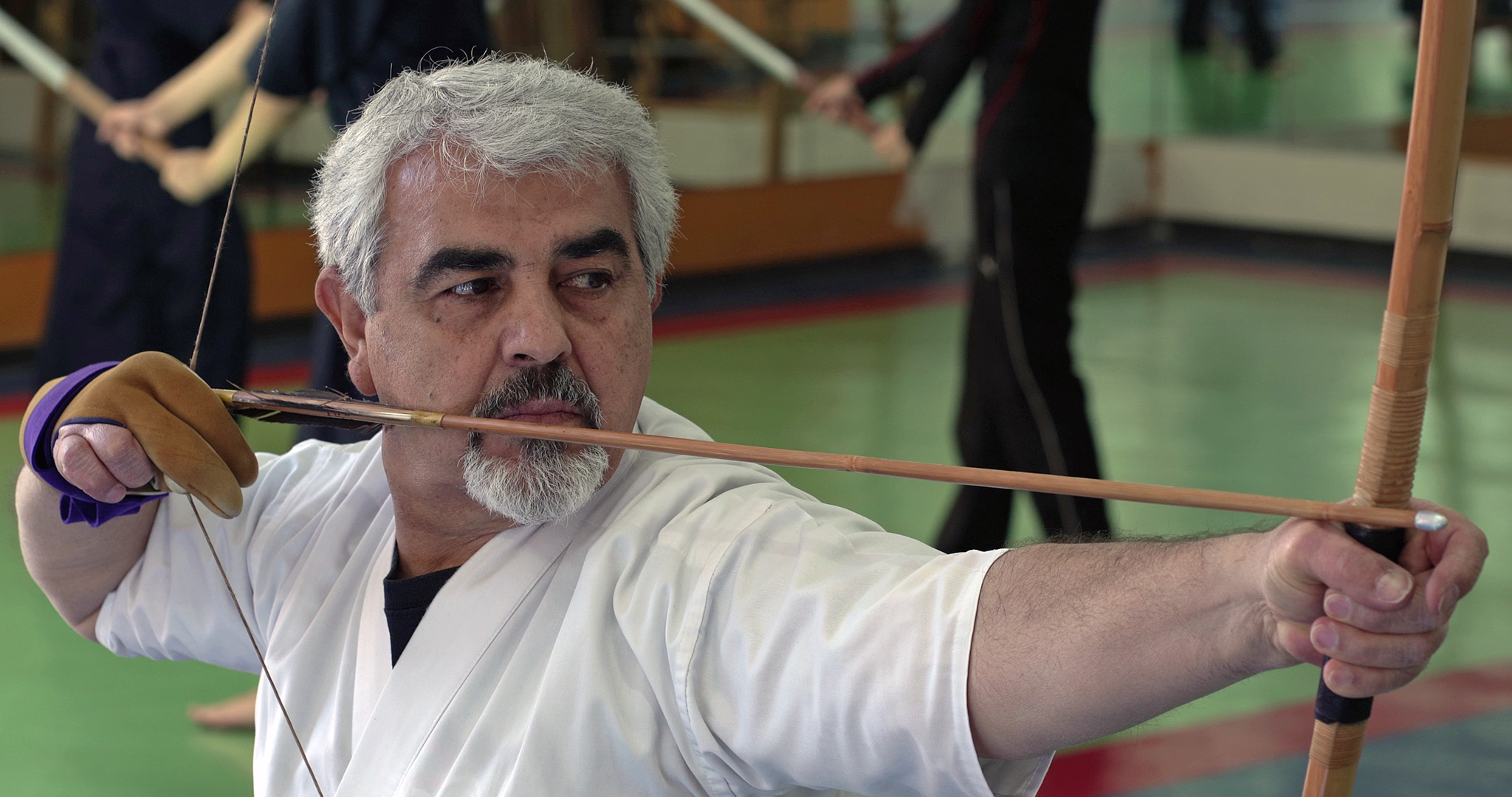 A foreigner practicing traditional Japanese archery, kyudo