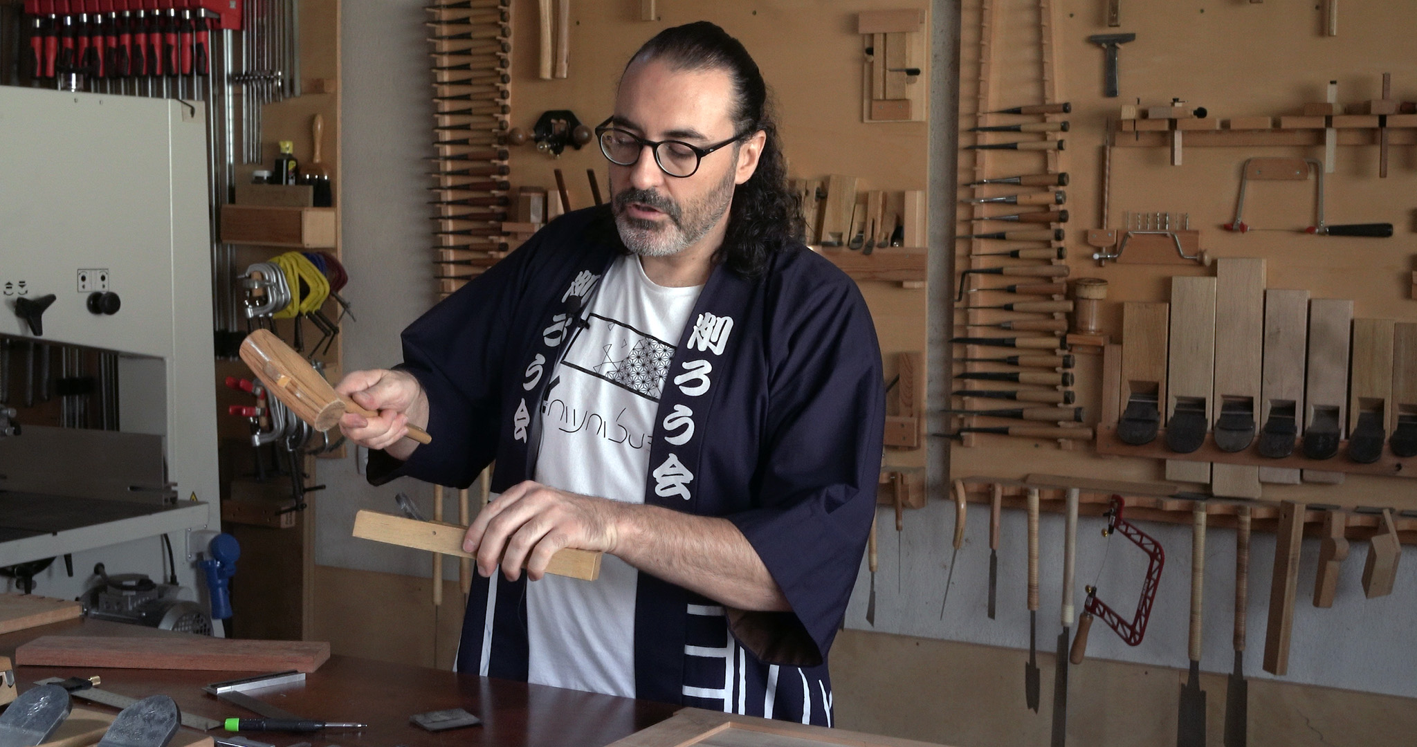 A man holding Japanese wood joinery tools